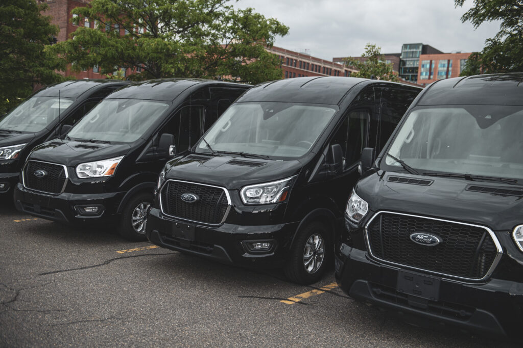 Side view of Ford 15 Passenger Medium Roof Transit passenger van rental