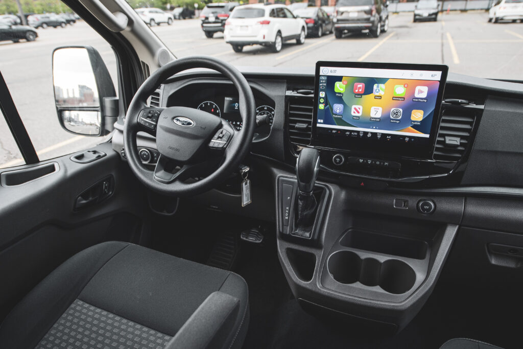 Interior dashboard and entertainment screen of a passenger van rental