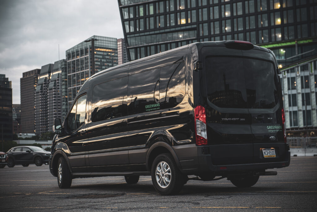 a black For Transit van in front of a cityscape