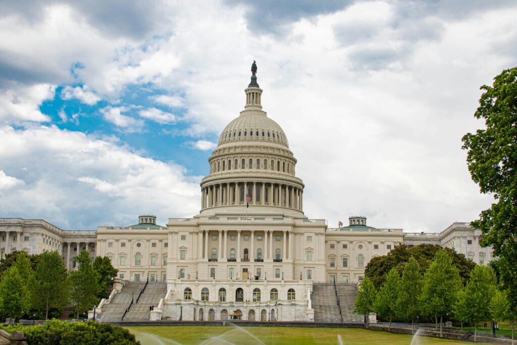 capitol building in DC under a blue sky with white clouds