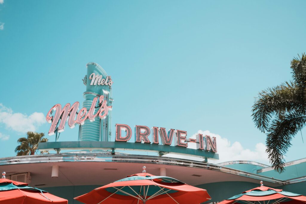 A sign in Disney World that says Drive In in 1960s font