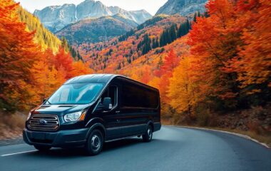 A black Ford Transit van driving through mountains covered in fall foliage