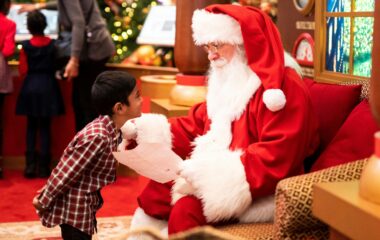 A young boy giving Santa a Christmas letter, Photo by __ drz __ on Unsplash