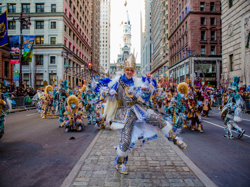 Mummers in bright costumes dancing down Broad Street in Philly on New Years Day