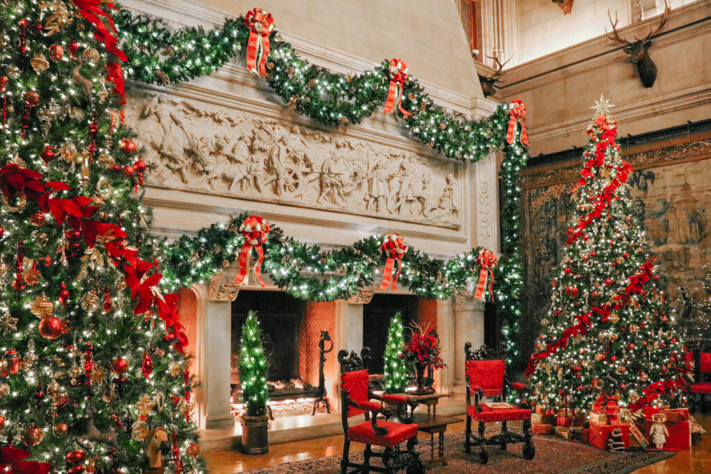 Elaborate Christmas decorations with red trimmings by the fireplace in Biltmore Estate Asheville North Carolina